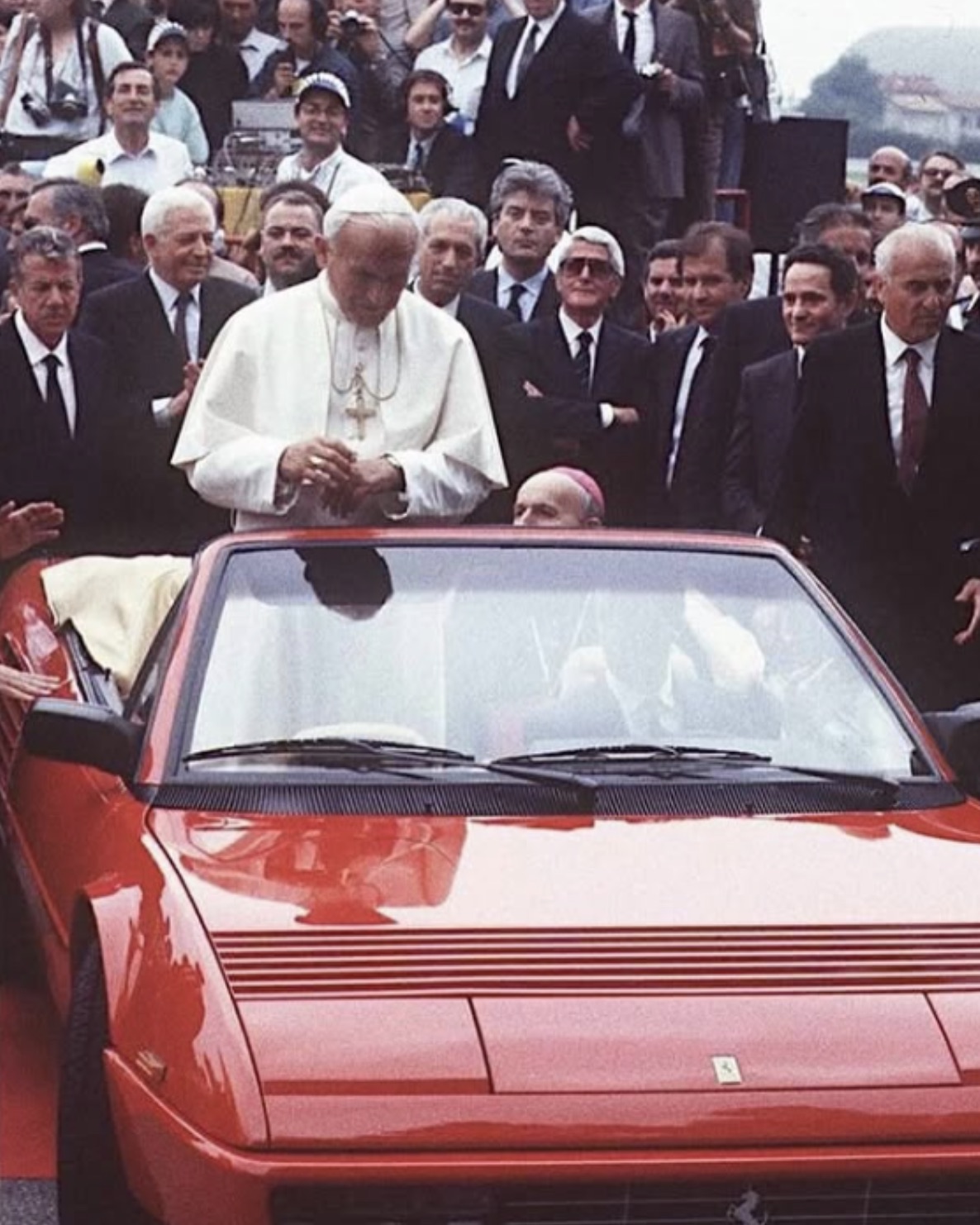 Pope John Paul II riding in a Ferrari 